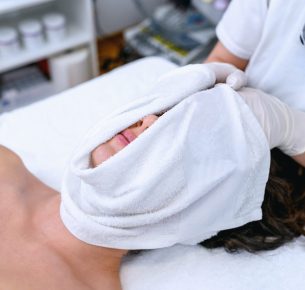 A beautician wrapped face with warm, wet towels.